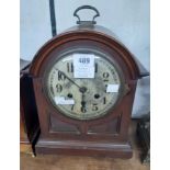 An early 20th Century mahogany and stained wood cased dome top bracket clock with Arabic numerals