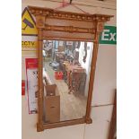 An antique pier mirror with beaded break-front pediment and original plate - later gilded finish