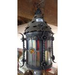 An old wrought iron and stained glass porch lantern