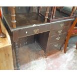 A 3' 3" Edwardian stained walnut single pedestal desk with frieze drawer and four pedestal