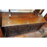 A 4' 11" 18th Century carved oak linen chest with adapted part folding top and decorative triple
