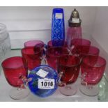 Nine Cranberry custard cups, a Cranberry glass sugar sifter, blue flash vase and two paperweights