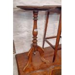 A Victorian mahogany pedestal wine table, set in turned pillar and tripod base