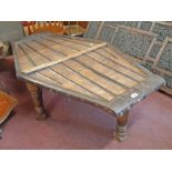 A 4' 5" Eastern iron bound hardwood coffee table of canted lozenge design with strap-work to top and
