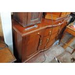 A 5' 7" Edwardian mahogany break bow front sideboard with three central drawers and flanking