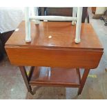 A vintage stained oak and mixed wood drop-leaf two tier tea trolley with drawer