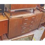 A 4' 6" 20th Century oak break front sideboard with four central drawers and flanking cupboard