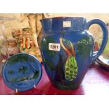 A large Torquay pottery jug decorated with moulded and painted peacock (a/f) - sold with a Lemon &
