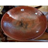 A large pottery bowl decorated with incised fish motif