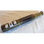 A vintage small brass three drawer telescope with leather grip