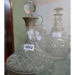 A cut glass ship's decanter with silver collar and associated stopper - sold with two other