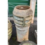A 34" high stoneware chimney pot with cowl top - damage to base