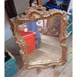 An ornate gilt plaster framed wall mirror - some rubs