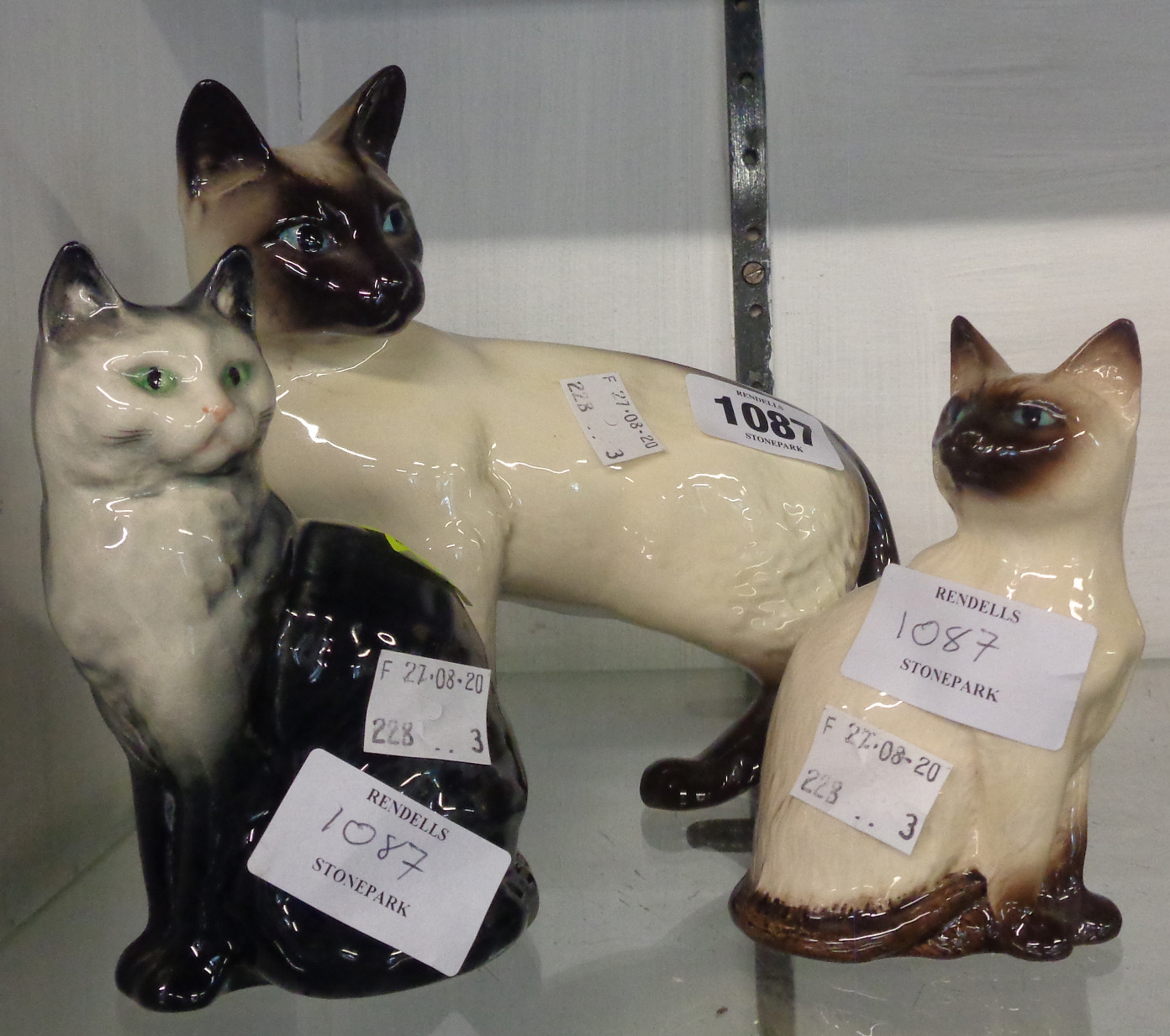 Two Beswick Siamese cats and another 1031 cat