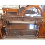 A 4' 5" Victorian carved oak two tier buffet with lion mask to the raised back and two frieze