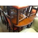 A 19th Century mahogany extending dining table with gadrooned edge and winder, set on heavy acanthus