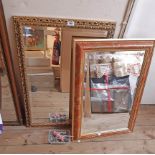 An ornate gilt framed bevelled oblong wall mirror with pierced border - sold with another with