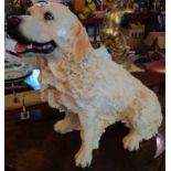 A large resin model of a golden retriever