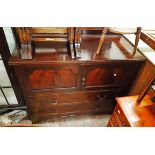 A 3' 6" 20th Century mahogany cabinet with two panelled cupboard doors over two long drawers, set on