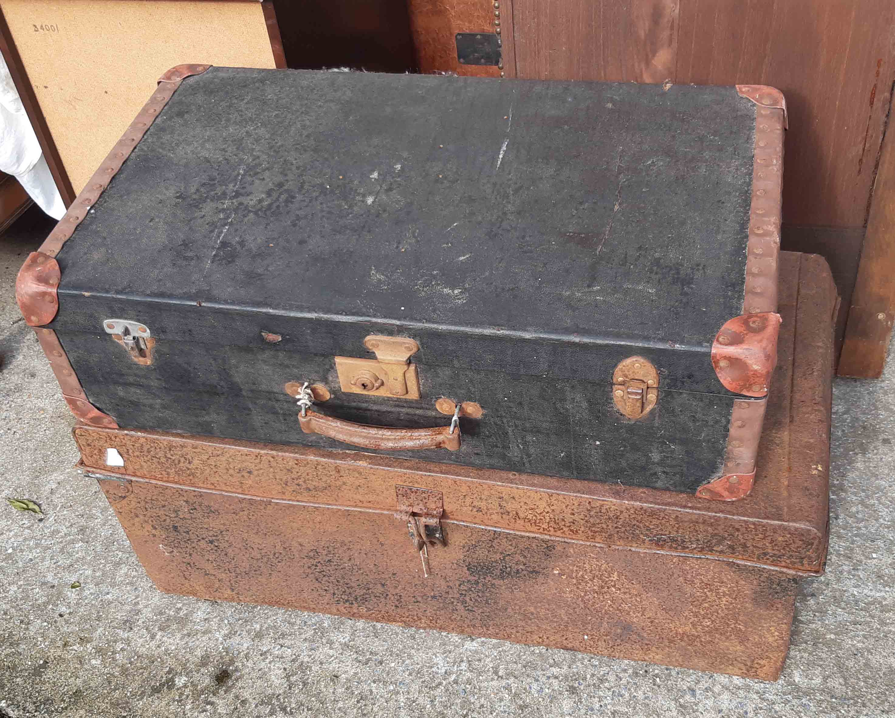 A metal trunk, a fibreboard suitcase, etc.