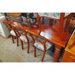 A 6' reproduction mahogany dining table with moulded top, set on heavy turned and reeded legs