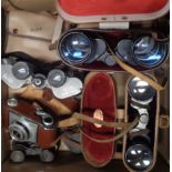 A box containing assorted cameras, binoculars, etc.