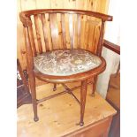 An Edwardian stained beech and strung framed slat back bow chair with upholstered seat panel, set on