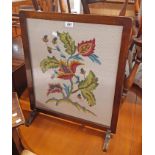 A stained oak framed fire screen with floral woolwork panel under glass - sold with a stained pine