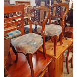 A set of six Victorian mahogany framed balloon back dining chairs with tapestry upholstered over