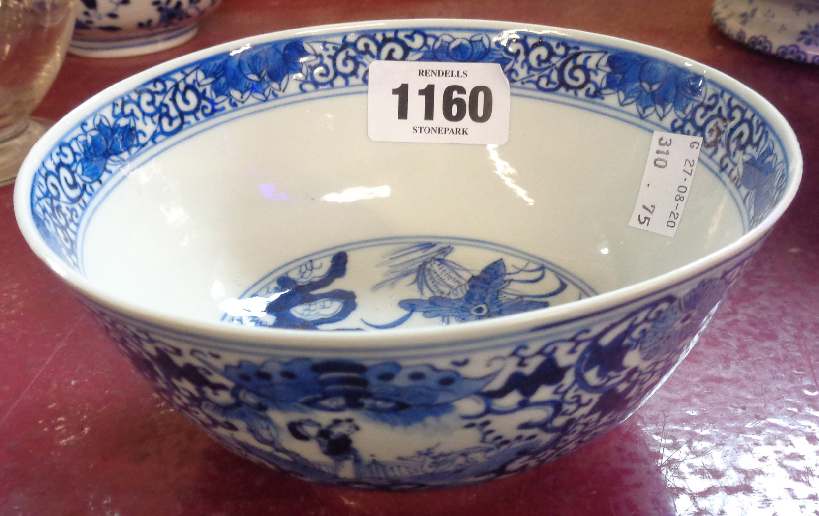 An antique Chinese blue and white bowl decorated with figure and flowers - Image 2 of 3