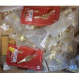 A box of brass sash window fittings