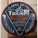 A reproduction cast metal Triumph motorcycle sign
