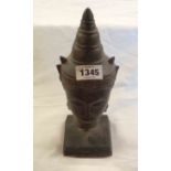 An antique bronze Khmer style head depicting Buddha, mounted on a wooden plinth