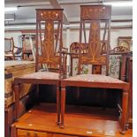 An Art Nouveau inlaid mahogany high back elbow chair with decorative splat and top rail, upholstered