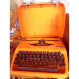 A vintage Dutch Adler Tippa typewriter in orange colourway