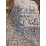A large decorative cutwork and filet lace bedspread