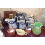 Assorted china including a set of three graduated relief moulded jugs, a decorative tile-set