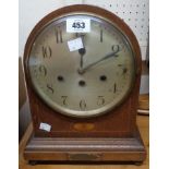 An Edwardian inlaid oak cased dome topped mantel clock with Junghans German eight day vertical