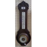 An early 20th Century oak backed wall barometer/thermometer with ceramic scale and visible aneroid