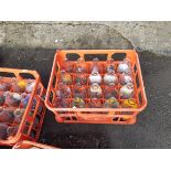 A vintage Unigate plastic milk crate containing twenty assorted advertising milk bottles