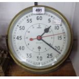 A 9" diameter brass cased bulkhead timepiece, the dial marked with broad arrow and 0552/160174 -