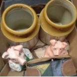 A box containing two Wade Nat West money boxes, two stoneware jars, and a vintage camera