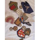 A bag containing assorted military and other embroidered patch badges