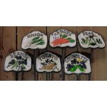 A set of six painted cast iron vegetable garden labels