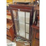 A 23" early 20th Century stained wood display cabinet with two glass shelves enclosed by a beaded