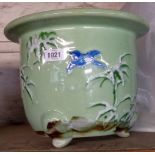 A 20th Century Oriental celadon glazed jardiniere decorated with foliage and a flying bird