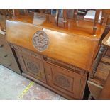 A 4' 19th Century walnut bureau base with carved roundel decoration and fitted interior over two