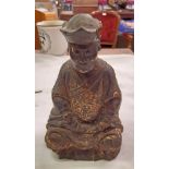 An antique carved wood and gilt figure of a seated Mandarin-a/f