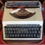 A vintage Imperial Messenger portable typewriter in soft case with manual and beginner's keyboard