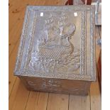 A 20th Century brass clad slope fronted coal box with embossed galleon decoration